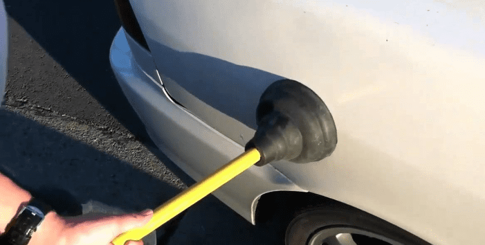 How to fix a small dent in a car using a plunger?